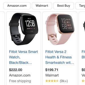 A Fitbit versa with blue band barley used